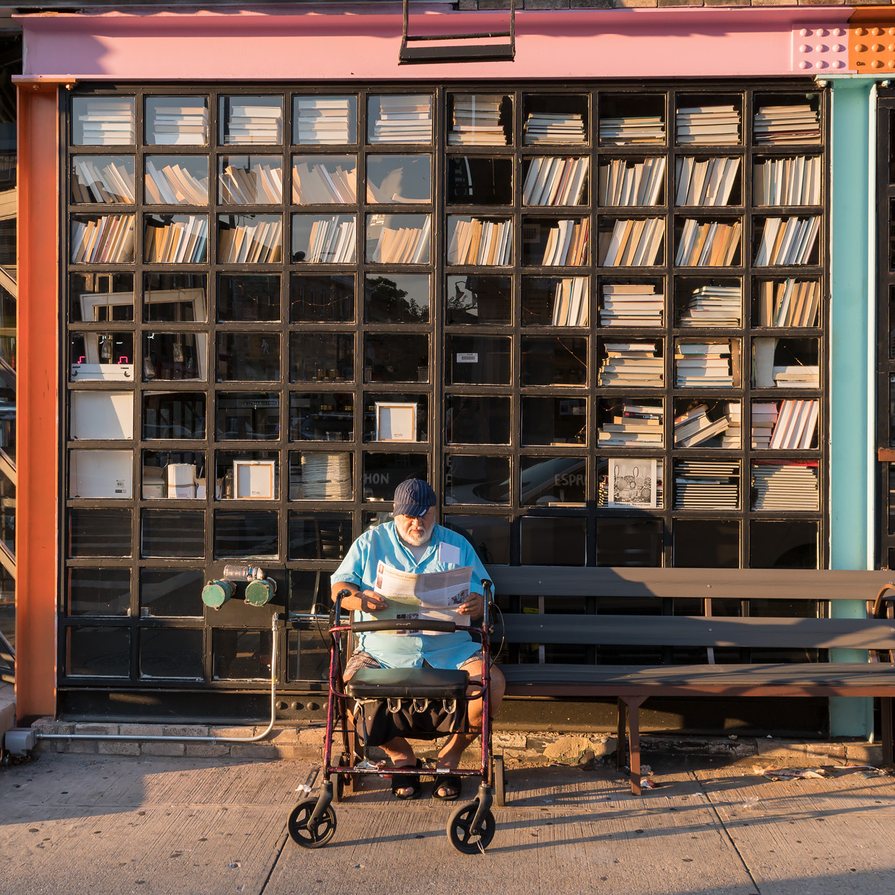 Photo: man reading on a bench in Brooklyn.