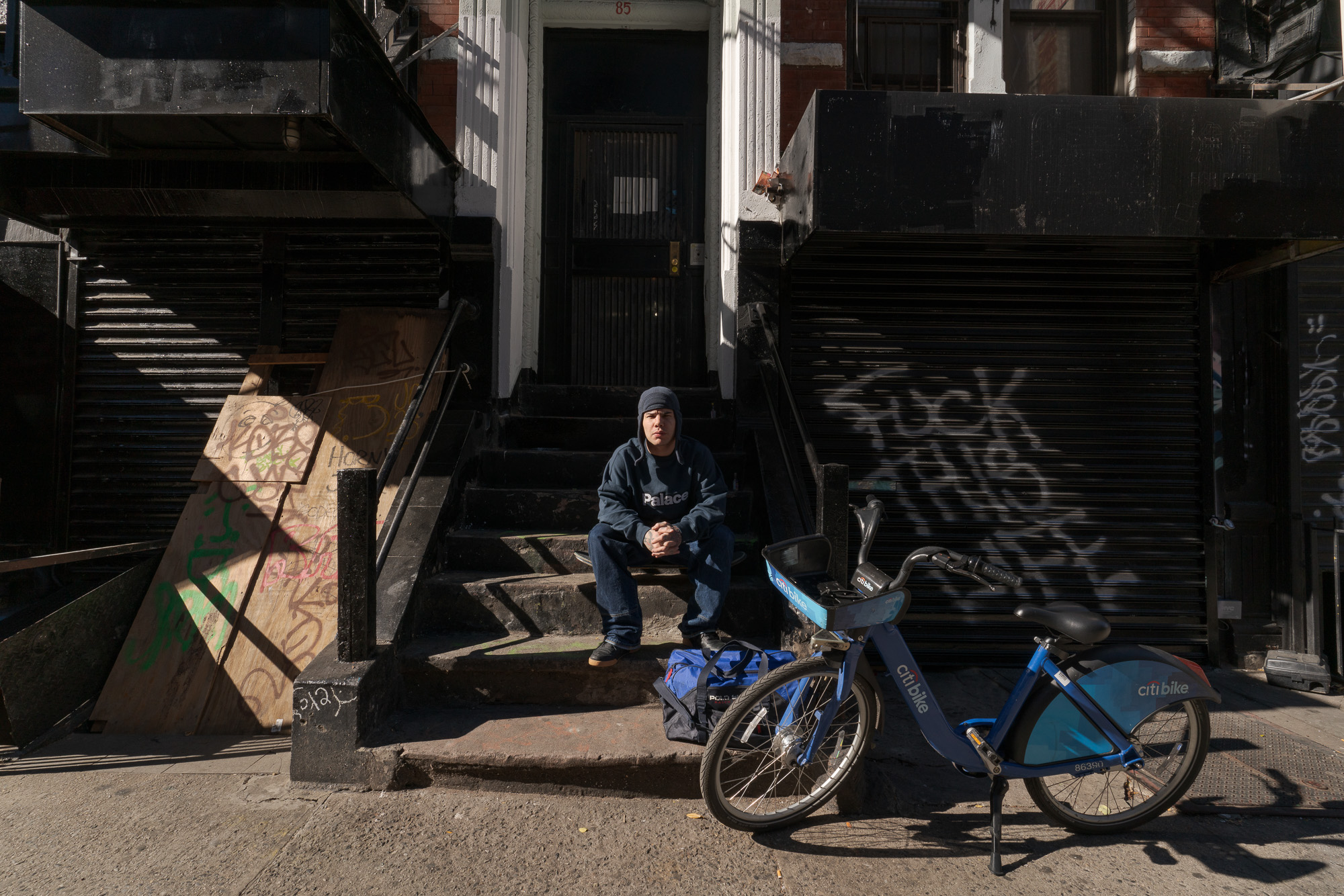 Photo: man sitting on a stoop, Lower East Side