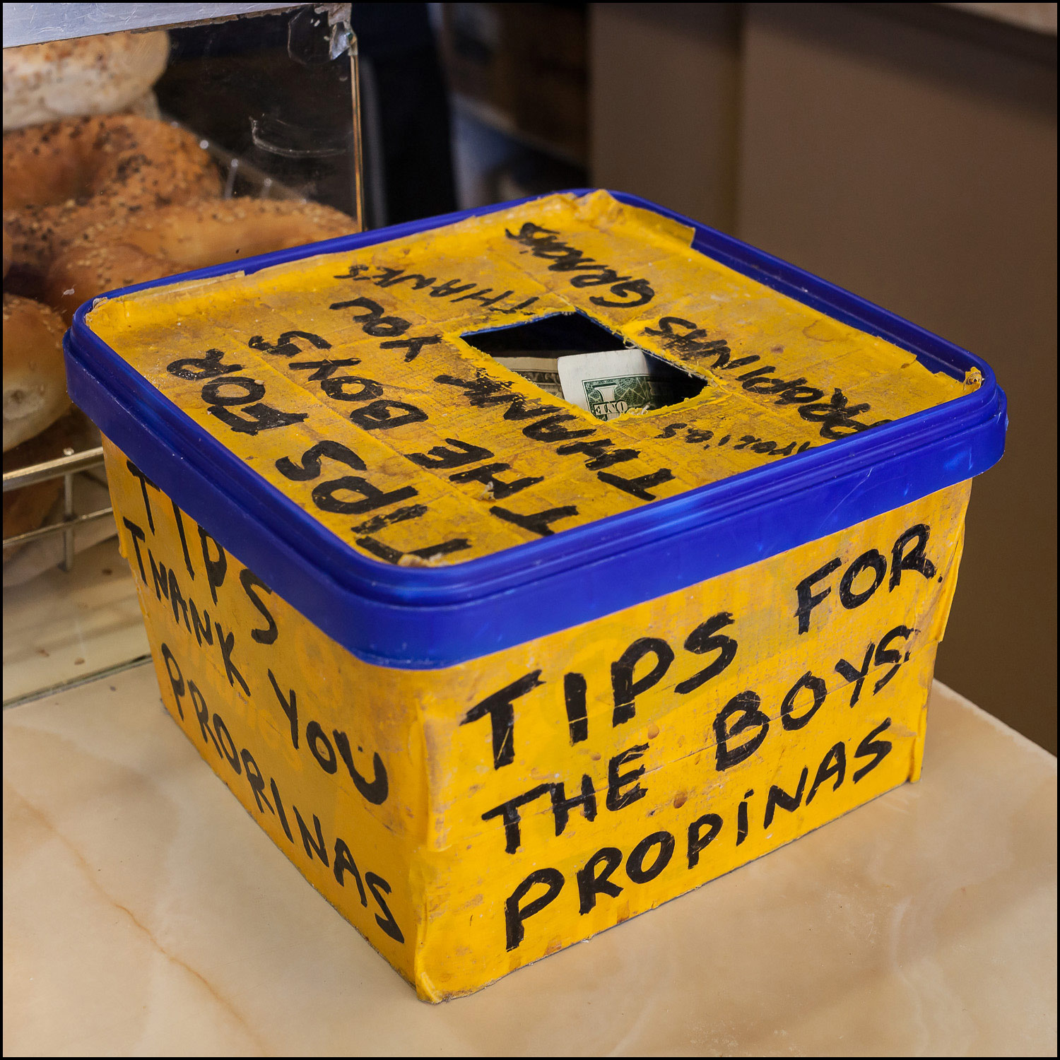 Photograph: bright yello box used as a tip jar