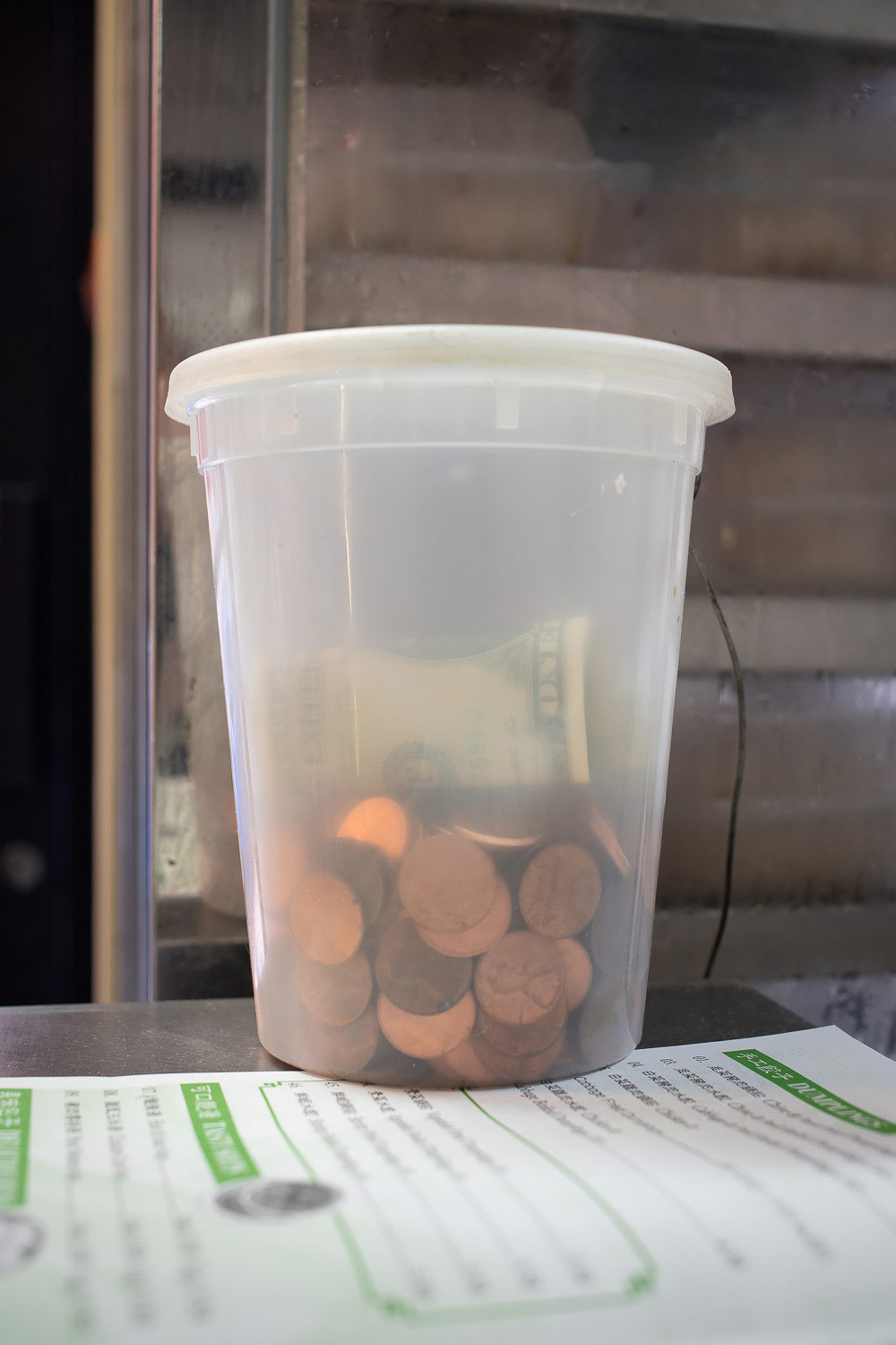 Photograph: plastic container used as tip jar.