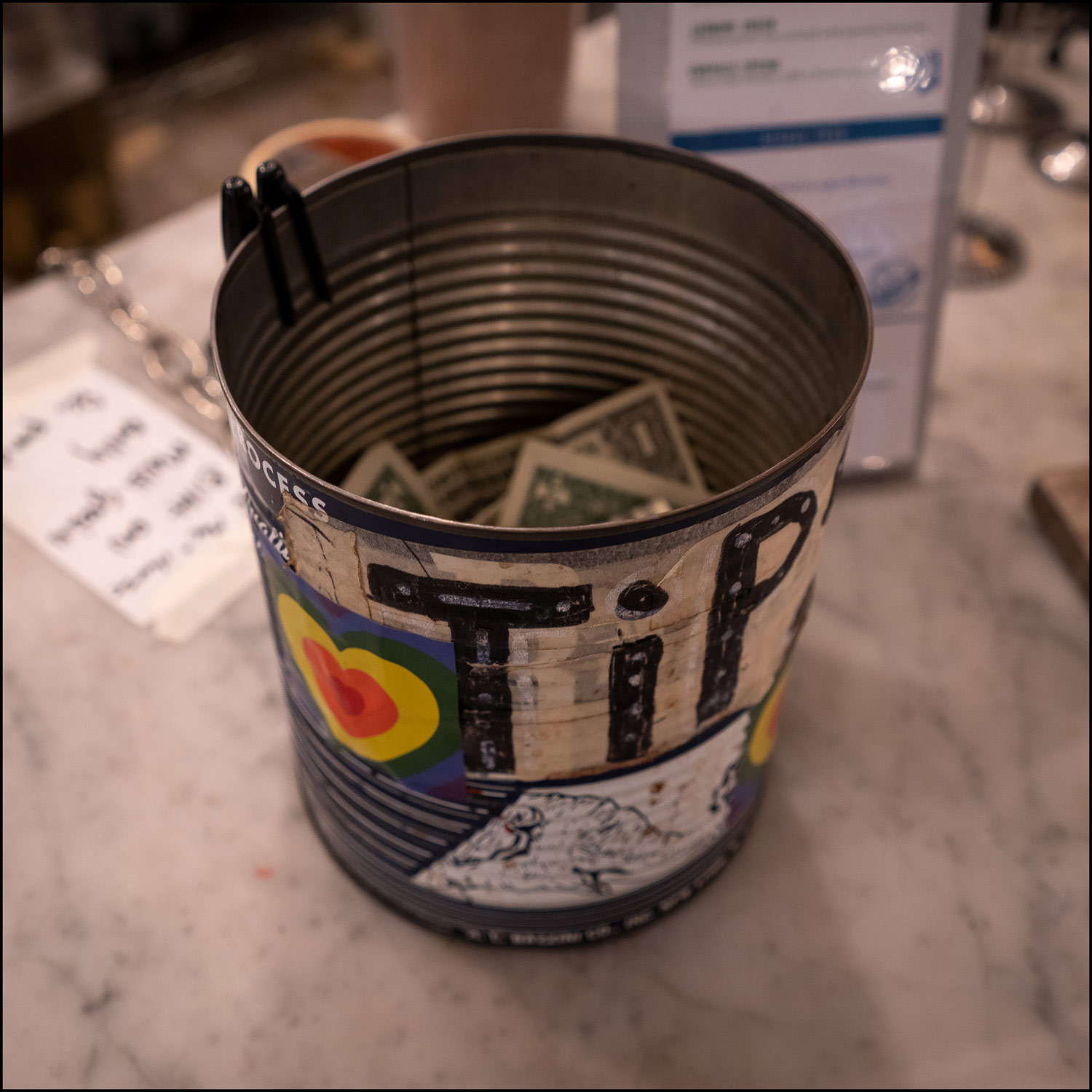 Photograph: metal can used for tip jar.
